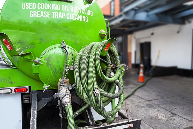 a service truck pumping grease from a restaurant's grease trap in Danville